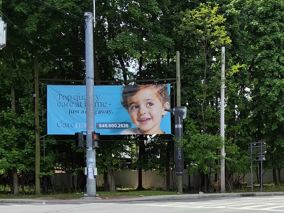 Large outdoor banner on a roadside frame by Marv'les Signs