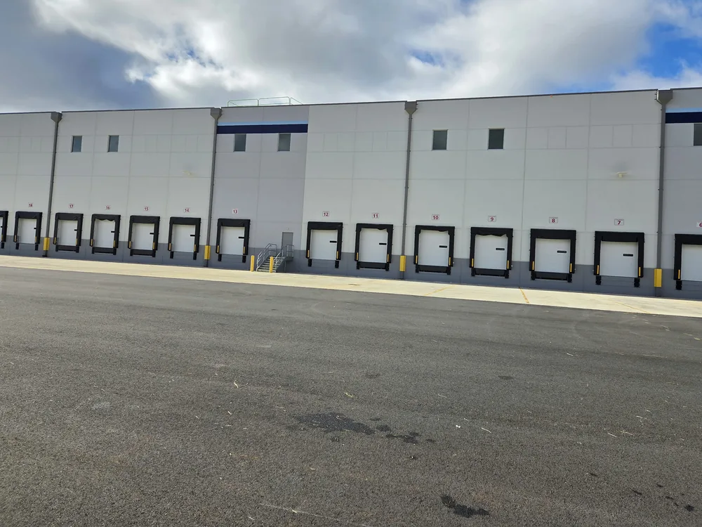 Numbered loading dock door signs on a warehouse by Marv'les Signs