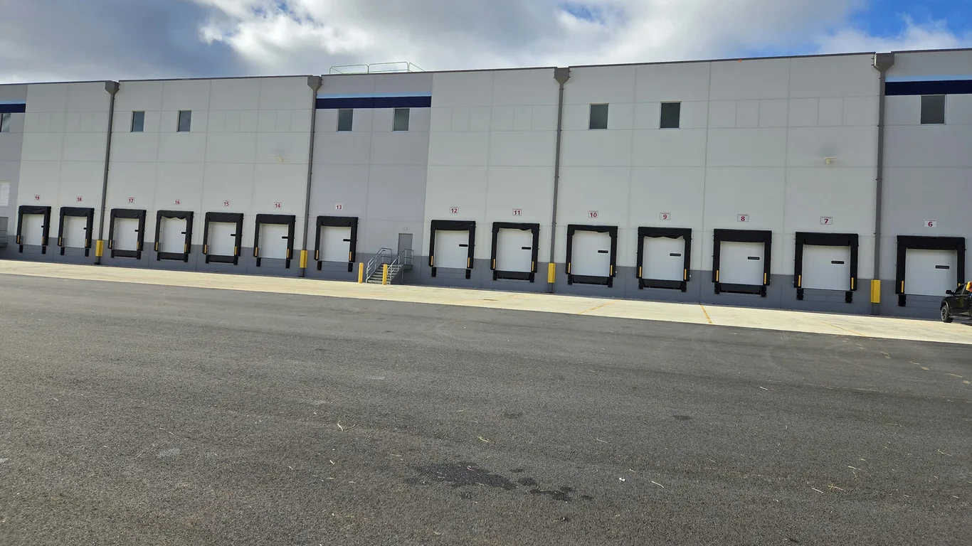 Numbered loading dock door signs on a warehouse by Marv'les Signs