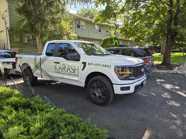 Vehicle lettering and graphics on a construction company pickup by Marv'les Signs