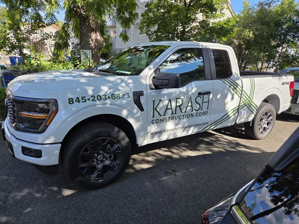 Vehicle lettering and graphics on a construction company pickup by Marv'les Signs